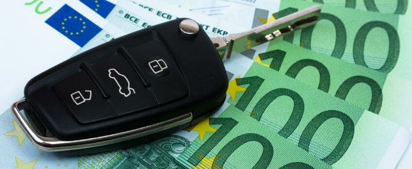 Car key on money background.